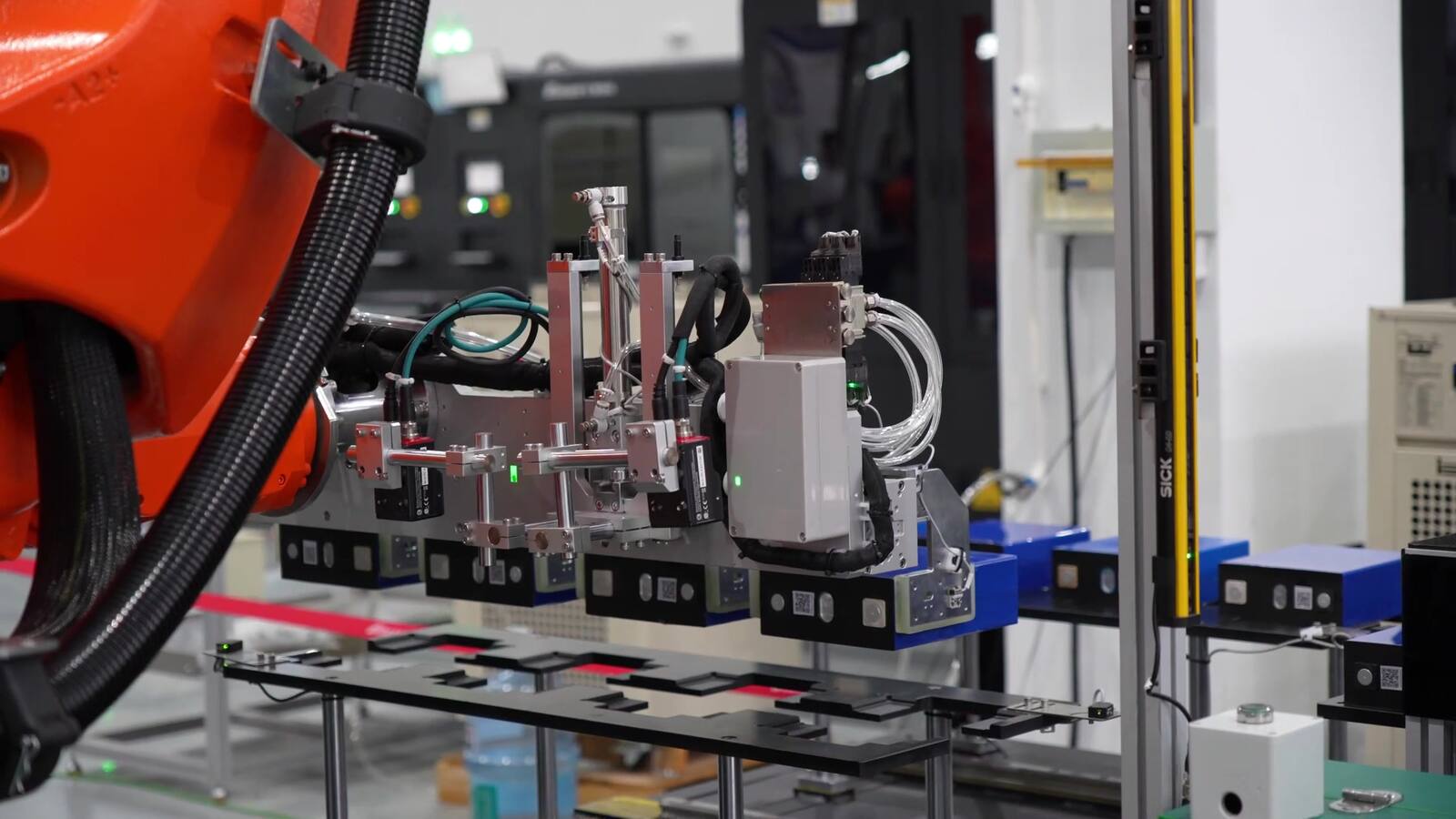 LBC automated assembly equipment using a robotic gripper to handle blue prismatic cells